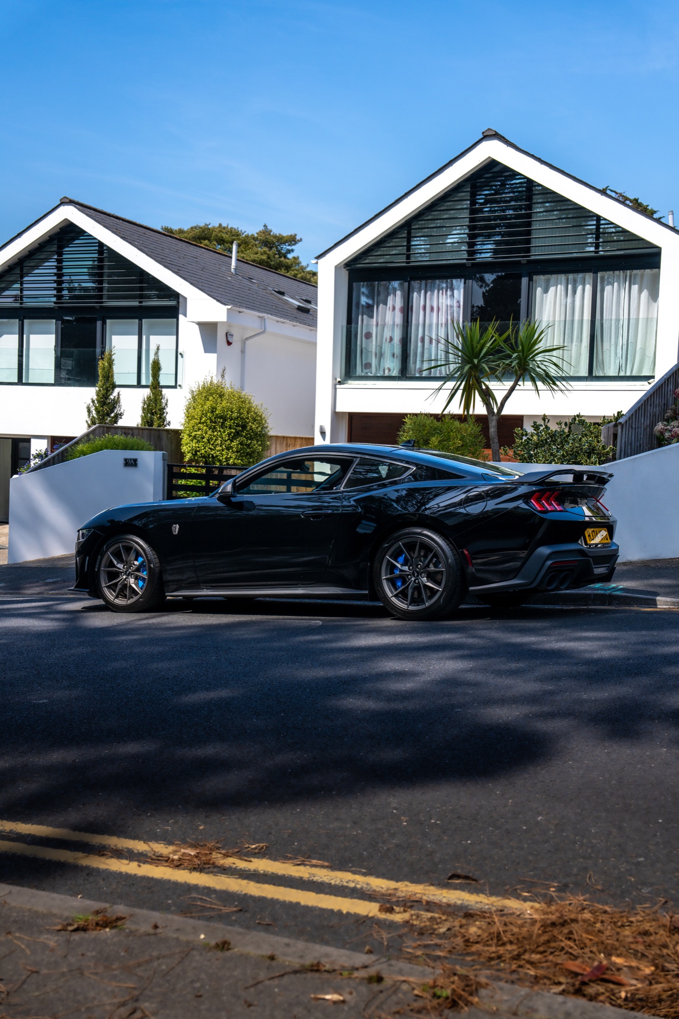 Black Mustang Dark Horse photographed against modern white architecture